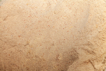 Close-up on the background and texture of yellow wooden sawdust that lie in a pile