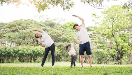 Family exercising and jogging together at the park. Group of asian family father mother and...