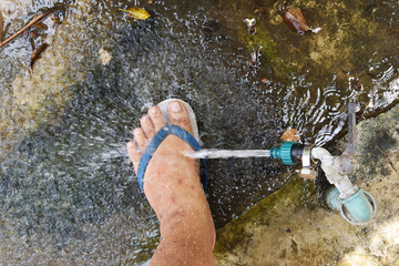Water from the water tap splashing on Human feet, Body cleansing