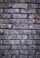 wall of white weathered bricks with shadows. vignette, background, texture.