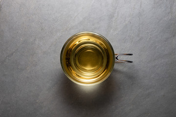 Top view photo of a mint tea cup over a stone background