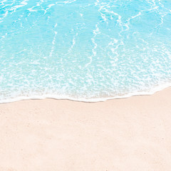 Fototapeta na wymiar Soft wave of blue ocean on sandy beach. Summer Background. Copyspace