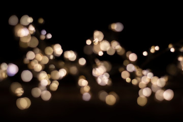 Abstract light blurred bokeh on dark background.