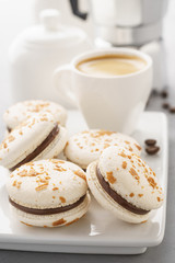 Chocolate macarons and a cup of coffee. Coffee break concept.
