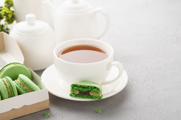 Pistachio macarons with berry filling and tea for dessert.