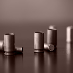 Old bullet cartridges on a dark background close up. Brown color toned