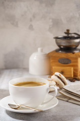 Black coffee and french macarons. Sunny morning breakfast.