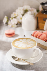 Cup of coffee and french macarons. Natural sunlight.