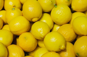 lemons or yellow limes stacked for retail sale