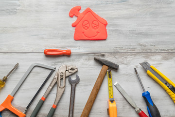 Set of work tool on rustic wooden background with icon of house in space, industry engineer tool concept.still-life.