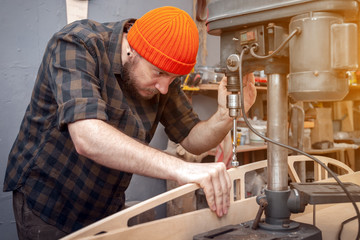 Construction Worker Using Drill To wood. Drill machine on the table in renovation work at home. Home repair concepts, close up.
