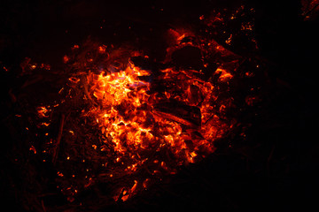 Fototapeta na wymiar Bright sparkling coals with fire as background