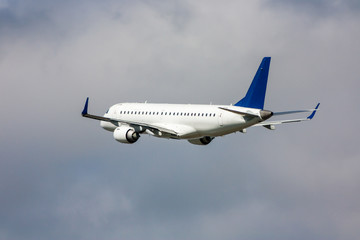 Fototapeta na wymiar White passenger jet plane in the air on take-off
