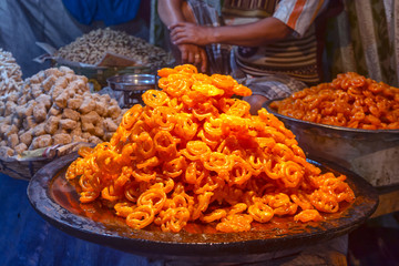Close Up Shot Of Freshly cooked traditional Indian dessert or sweets Jalebi is selling at local market.