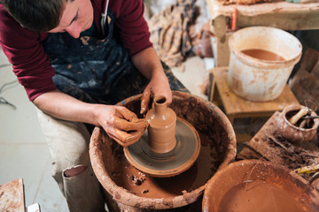 Potter at work. Workshop place.