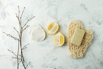 Set of eco friendly zero waste treatment for bodycare - massage brush, sponge, soap on a light background, top view. Cleansing of skin, scrub, anti-cellulite health concept.