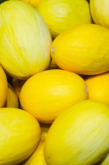 yellow melons stacked for retail sale