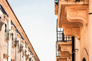 Balcony of old baroque building in Catania, traditional architecture of Sicily, Italy.