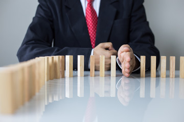 Stopping the domino effect concept for business solution, strategy and successful intervention
