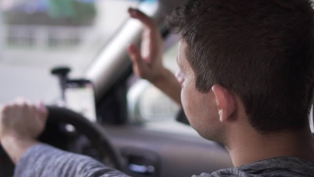 Annoyed driver in the car is angry because of traffic jam, slow motion.