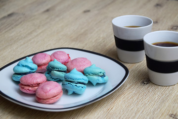 Coffee break with two cups of coffee and french cookies - known as macarons.