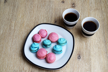 Cup of coffee and pink and blue macarons