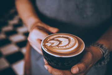 Fototapeta na wymiar Professional Barista Making coffee latte art in cafe.