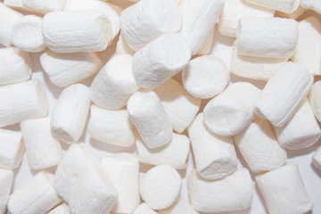 Top view of Fluffy white marshmallow  isolated on white background. Sweet food. Background or texture of  mini marshmallows. Close-up. Marshmallows food background.