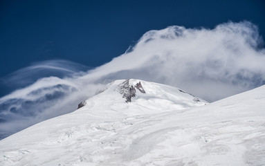 Fototapeta na wymiar Amazing perspective of caucasian snow mountain or volcano Elbrus with blue sky background.
