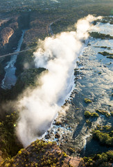 The Victoria falls is the largest curtain of water in the world. The falls and the surrounding area is the Mosi-oa-Tunya National Parks and World Heritage Site (helicopter view) - Zambia, Zimbabwe. Af