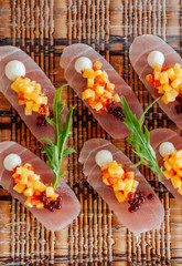 Fresh snapper Tataki with mango salsa and arugulas