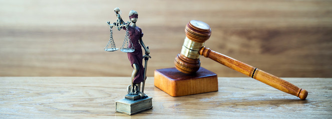 Law and justice concept image. Brown wooden background