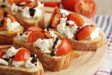 Sandwiches with tomatoes, homemade cheese, olive oil and balsamic sauce