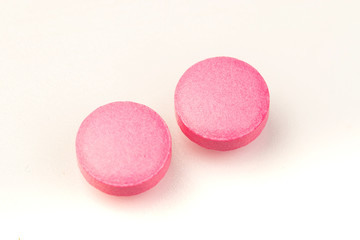 Obraz na płótnie Canvas pink tablets on white background