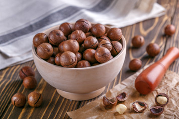 macadamia nuts on wooden surface. natural healthy food.