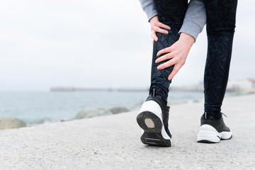 Leg muscle cramp calf sport injury outdoors exercise. - obrazy, fototapety, plakaty