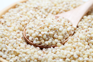 Sorghum rice with wooden spoon in a bowl. Close-up.