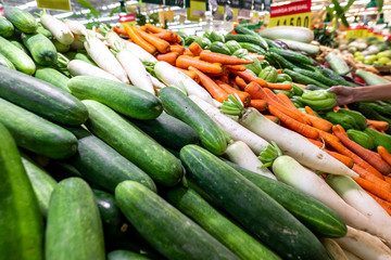Green and fresh organic cucumbers background. Local food market on Bali island.