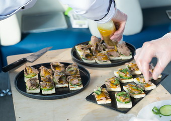 The chef covers the table with a variety of snacks.