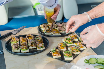 The chef covers the table with a variety of snacks.