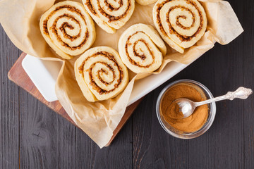 Raw cinnamon buns on a baking sheet