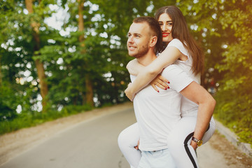 Beautiful couple spend time in a summer park