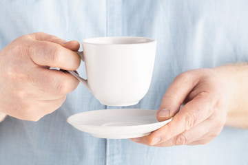 man hand holding coffee or tea mug