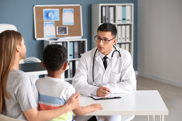 Fototapeta premium African-American boy with mother at pediatrician's office