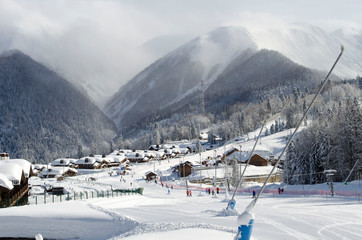 Scenic view of mountain slopes and apartments at ski resort Laura Russia