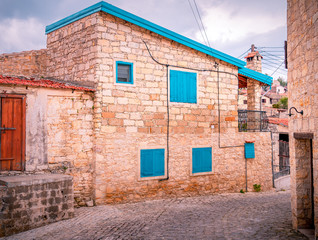 Fototapeta na wymiar Old stone houses on a narrow streets in the picturesque medieval city of Lofou. Limassol District, Cyprus