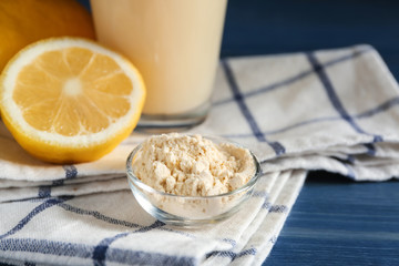 Bowl with protein powder on table