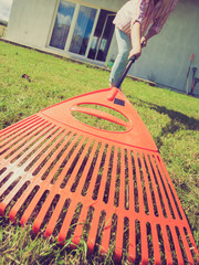Unusual angle of woman raking leaves