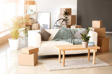 Furniture, belongings and moving boxes in room