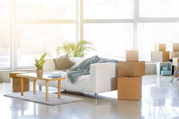 Furniture, belongings and moving boxes in room